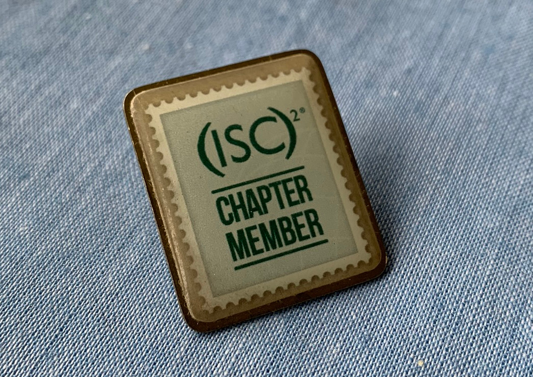 Photo of a lapel pin with the (ISC)² Chapter Member logo