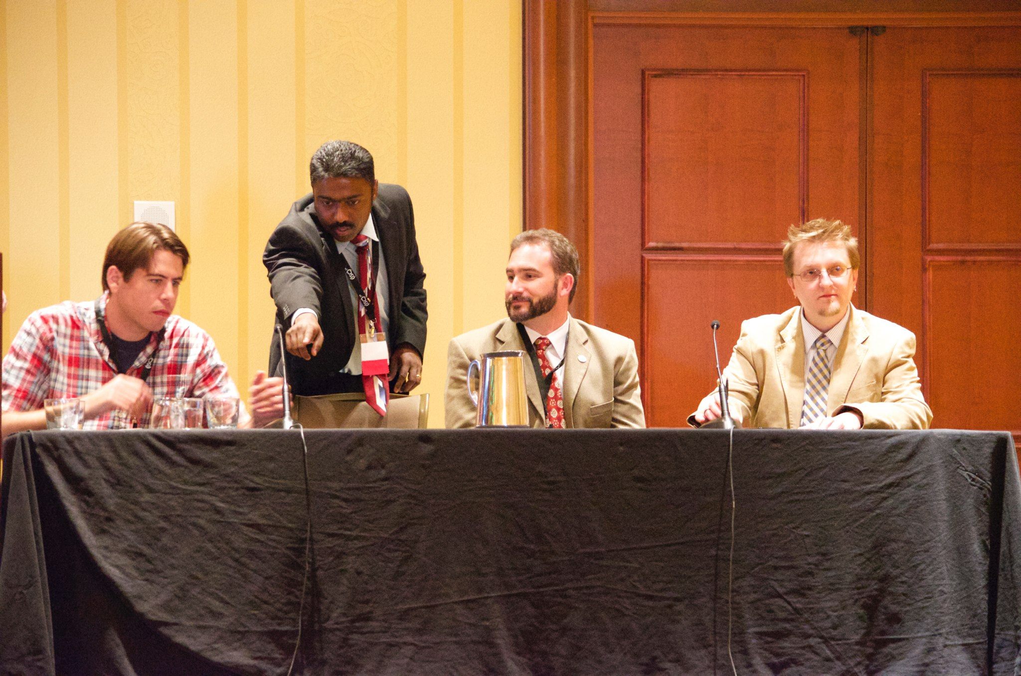 Donald sitting at a table with other members of a discussion panel